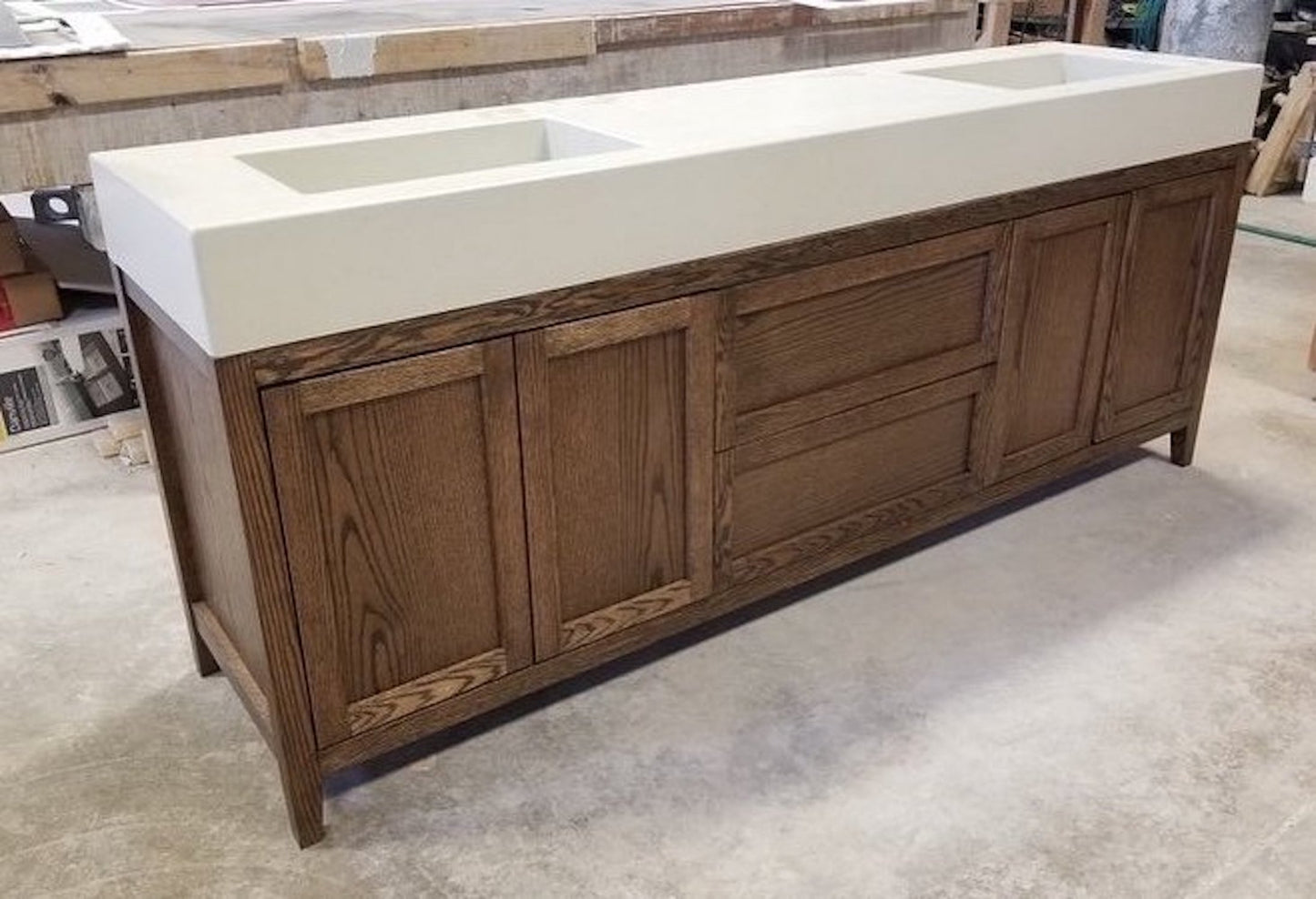 A double vanity cabinet with a beige countertop and brown wooden body, featuring a contemporary design with soft close doors and drawers.